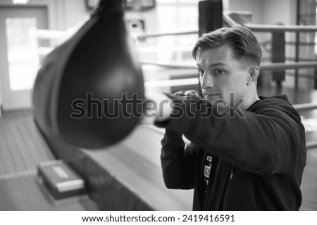 Close up black and white picture, MMA fighter sports and warrior in gym for mma or mixed martial arts training. Boxer, boxing athlete hands boxing bag Royalty-Free Stock Photo #2419416591