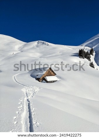 Snowy alp in the Glarus mountains. Beautiful mountain landscape. Hut discovered on a ski tour. High quality photo
