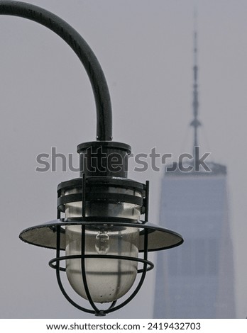 color photo of a single close up lamppost in Liberty State Park, Jersey City, New Jersey with the New York City freedom tower in the background