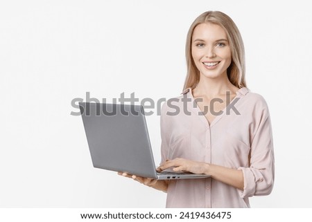 Happy smiling woman in casual holding laptop with look in camera. E-learning e-commerce e-banking concept. Caucasian female with freelance remote project Royalty-Free Stock Photo #2419436475