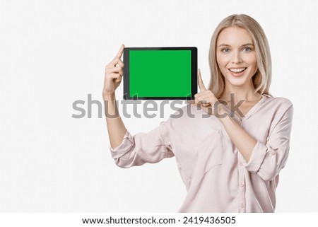 Image of cheerful caucasian woman showing display of digital tablet. Green screen mockup for free empty copy space. Advertisement concept