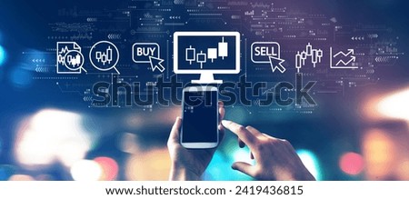 Stock trading theme with a smartphone in blurred city lights at night