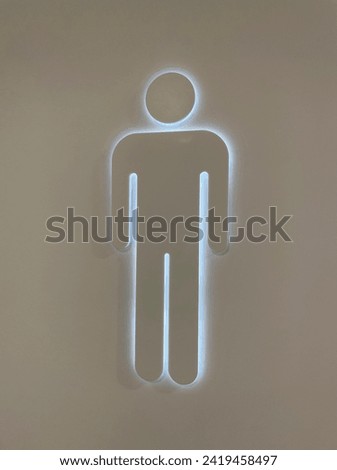 Interior close up photo view of a human slhouette icon design indicating a gents male man restroom toilets batheroom in a public plc like a mall or restaurant hotel