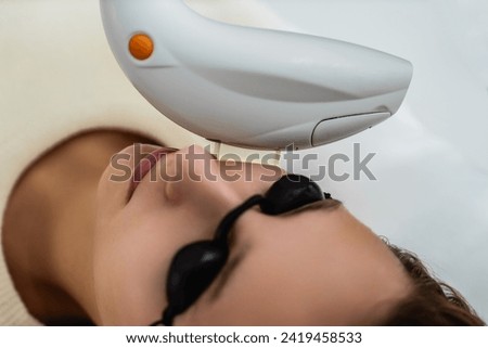 Phototherapy, photorejuvenation, IPL in a beauty salon. Care for a woman's face. High quality photo