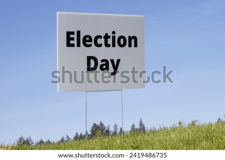 Election Day lawn sign against clear blue sky background.