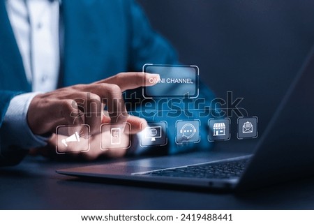 Omni Channel concept. Businessman use laptop with virtual omni channel icons for business and social media marketing. Royalty-Free Stock Photo #2419488441