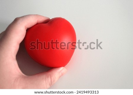 Red heart shape isolated on white,A woman hold a red heart in her hands,Happy Valentine's Day