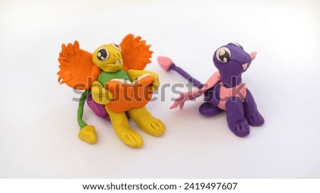 Child making colorful plasticine dragons family and creating. Fairy tale card with cartoon animals.	