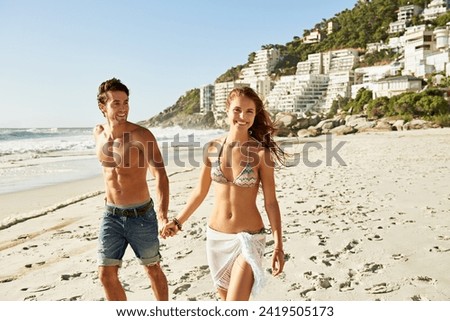 Love, holding hands and couple walking at a beach with freedom, fun and bonding in nature together. Travel, care and happy people at sea for summer, romance or anniversary vacation in South Africa Royalty-Free Stock Photo #2419505173