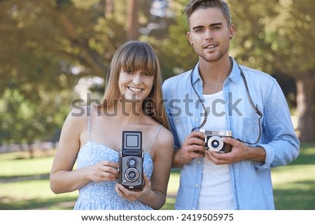 Portrait, park and happy couple of friends with vintage camera for outdoor photography, photo memory or tourism. Retro equipment, creative photographer and people smile for spring picture in nature