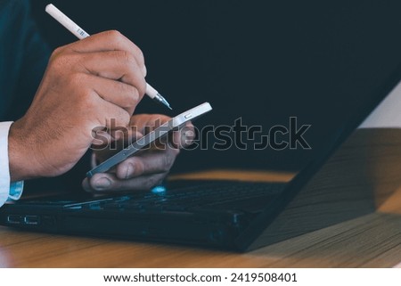 A close-up photo shows a businessman working with a laptop on his desk.