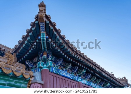 Beautiful Chinese architectural ornament adorning roof corner at a historical traditional palace used by the Chinese Royal Families.