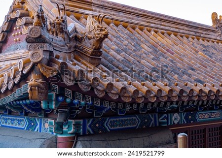 Beautiful Chinese architectural ornament in the form of a dragon head adorning a roof at a historical traditional palace used by the Chinese Royal Families.