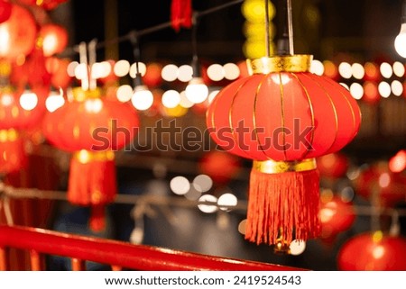 An image of several red Chinese lanterns in the right corner and a bokeh background in celebration of Chinese New Year culture. for tourists to come see and take pictures for memories