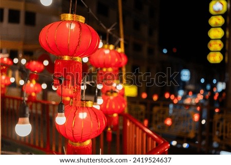 Chinese New Year Festival in Chinatown Groups of red lanterns and light bulbs are hung along the walkway. Has beautiful bokeh for people to come visit and take pictures To celebrate good culture