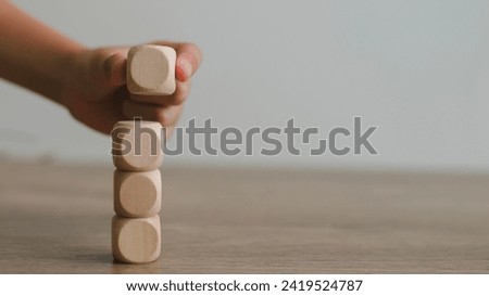 Businesswomen stack blank wooden cubes on the table with copy space, empty wooden cubes for input wording, and an infographic icon