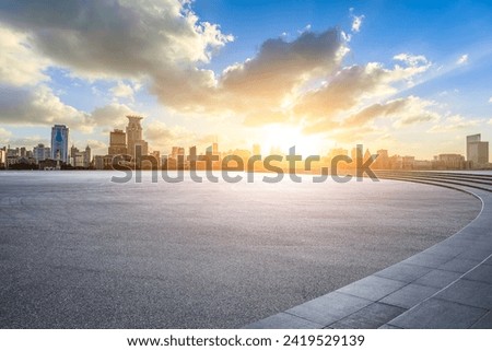 Asphalt road square and modern city buildings at sunset in Shanghai