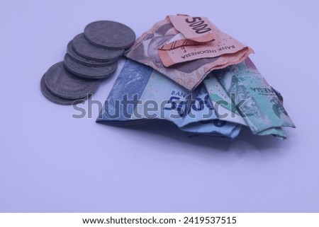A collection of banknotes and rupiah coins is a tool used for buying and selling transactions