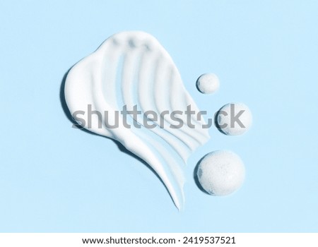 cosmetic smears of creamy texture on blue background
