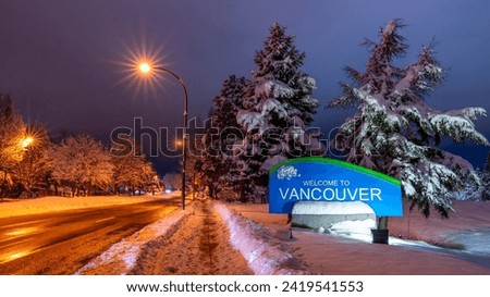 Vancouver, British Columbia, Canada. The "Welcome to Vancouver" sign as seen entering Vancouver at night after a snowstorm.