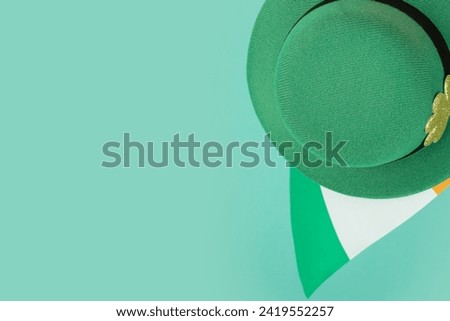 green irish leprechaun hat with gold clover and irish flag on green background