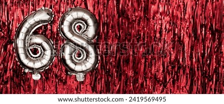 Silver foil balloon number, digit sixty-eight on red background. Birthday greeting card with inscription 68. Anniversary celebration event. Banner. Numerical digit. Copy space