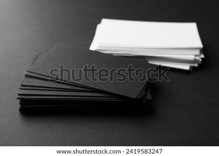 Many business cards on black background, closeup. Mockup for design