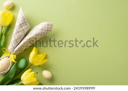 Bunny-inspired Easter charm. Overhead photo of a table adorned with an egg in bunny-ear napkin, stunning yellow tulips, and sugar sprinkles on a pastel green background. Adaptable for text or adverts