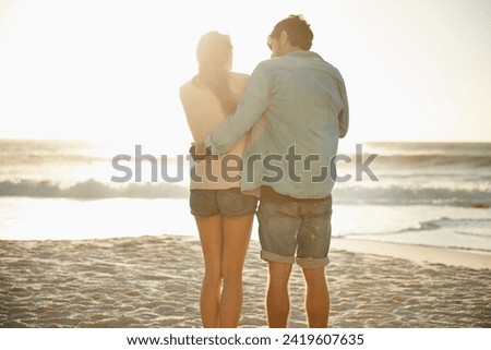 Beach, sunset and back of couple in nature with hug, support or romance while bonding with love. Summer, freedom and people embrace or sunrise with ocean view, date or anniversary on Florida vacation
