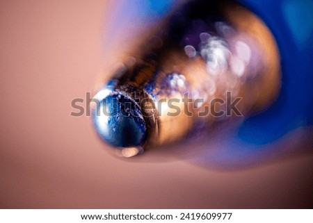Elegant close-up macro photography of a shiny copper ballpoint pen tip with a smooth blurred background, showcasing the precision and craftsmanship of this writing instrument Royalty-Free Stock Photo #2419609977