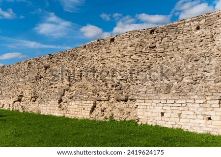 Old fortress wall made of natural stone in Izborsk, Russia.