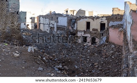 A panoramic view reveals the embrace of the quake - Amizmiz in ruins, a desolate panorama marked by collapsed edifices, debris-strewn streets, and the poignant aftermath of nature's embrace Royalty-Free Stock Photo #2419653679