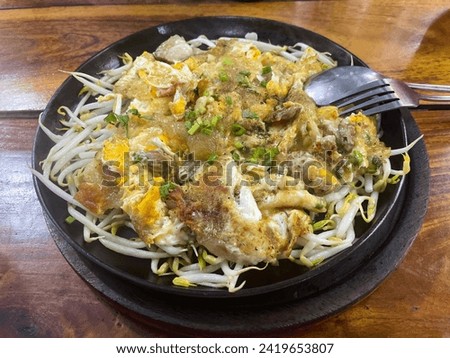 Pad Thai, a Thai food menu with noodles, vegetables, lemon, spices, bean sprouts, a healthy menu. oriental food Pad Thai on a hot plate The colors look delicious.