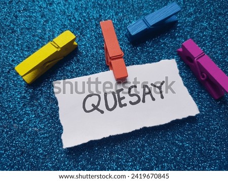 Quesay writting on blue background.