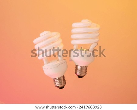 Two light bulbs and reading, the coziness of the room. Light and brightness. Royalty-Free Stock Photo #2419688923