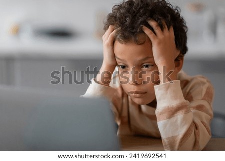 Homeschooling Difficulties. Upset Black Boy Using Laptop At Home And Touching Head, Stressed Preteen Male Child Tired Of Doing Homework, Depressed Kid Sitting At Desk With Computer, Free Space
