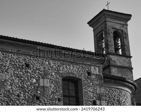 Italian Landscape: Church of St. Alexander, in Seriate (Bergamo province). XIIth century. Romanesque and baroque style, mixed over the centuries. Known as church of the plague. BW. Winter season
