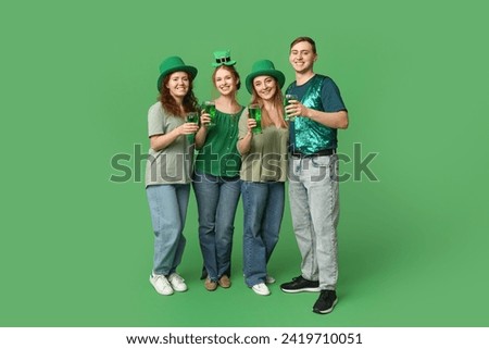 Group of people with beer on green background. St. Patrick's Day celebration