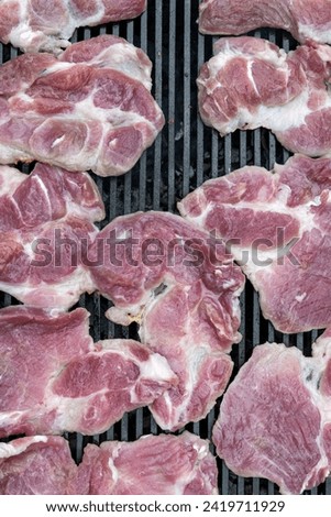 Pork (pork neck) grilled on charcoal. Shot from above. It's time to grill! Barbecue. Meat steak grilled on a stainless steel grill.	