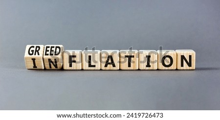Inflation or greedflation symbol. Concept word Inflation Greedflation on beautiful wooden cubes. Beautiful grey table grey background. Business inflation greedflation concept. Copy space.