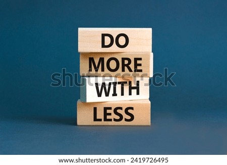 Do more with less symbol. Concept word Do more with less on beautiful wooden block. Beautiful grey table grey background. Business do more with less concept. Copy space. Royalty-Free Stock Photo #2419726495