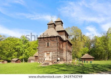 Old wooden church in Pirogovo (Church of the Resurrection from Poltava) in Kyiv, Ukraine Royalty-Free Stock Photo #2419743749