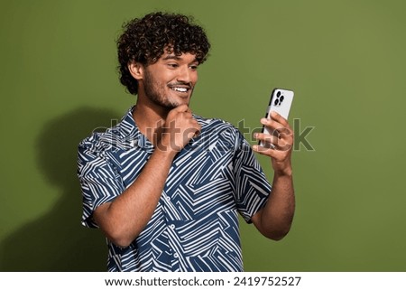 Photo of smart clever man dressed print shirt reading messages modern gadget empty space isolated green color background