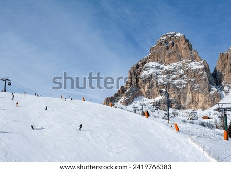 Ski resort in the Dolomites. Mountain recreation place. Ski slopes in the Dolomites on a clear sunny day. Alpine skiing sport and recreation. Royalty-Free Stock Photo #2419766383