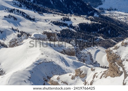 Ski resort in the Dolomites. Mountain recreation place. Ski slopes in the Dolomites on a clear sunny day. Alpine skiing sport and recreation. Royalty-Free Stock Photo #2419766425