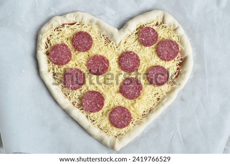 beautiful pepperoni pizza for valentine's day in the shape of a heart.