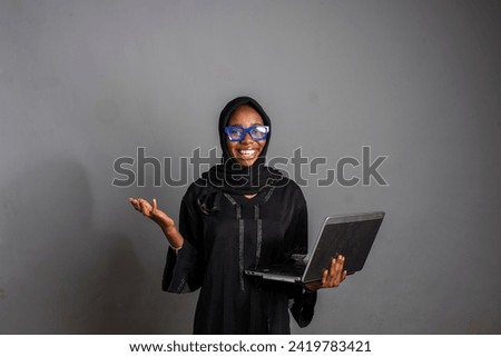 beautiful and stylish african lady using her laptop computer