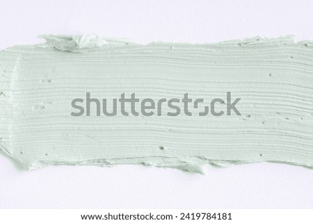 Green clay mask or correcting concealer smear smudge on white background. Cream texture. Facial mask, skincare beauty product swatch closeup. SPA background Royalty-Free Stock Photo #2419784181