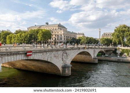 Paris, France; 25 July, 2022: Traditional French architecture buildings and bridge along the Seine River promenade, boat ride. Paris, France. Royalty-Free Stock Photo #2419802691