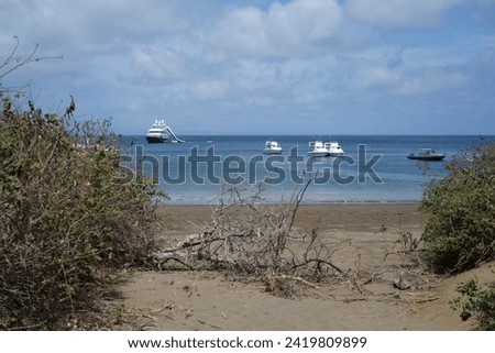 White tourist boats near sandy beach  of Plata island, Ecuador